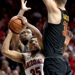 Arizona guard Allonzo Trier (35) looks for room to get off a shot between Southern California forward Chimezie Metu, left, and forward Nick Rakocevic during the first half of an NCAA college basketball game Saturday, Feb. 10, 2018, in Tucson, Ariz. (Kelly Presnell/Arizona Daily Star via AP)