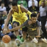Oregon's Troy Brown Jr., left, and Arizona State's Shannon Evans II race for a loose ball during the second half of an NCAA college basketball game Thursday, Feb. 22, 2018, in Eugene, Ore. (AP Photo/Chris Pietsch)