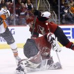 Arizona Coyotes goaltender Antti Raanta, front right, makes a save on a shot by Anaheim Ducks center Ryan Kesler (17) as Coyotes defenseman Kevin Connauton, back right, collides with Raanta during the first period of an NHL hockey game Saturday, Feb. 24, 2018, in Glendale, Ariz. (AP Photo/Ross D. Franklin)
