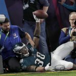 Philadelphia Eagles' Corey Clement crashes into photographers after catching a touchdown pass during the second half of the NFL Super Bowl 52 football game against the New England Patriots Sunday, Feb. 4, 2018, in Minneapolis. (AP Photo/Matt York)
