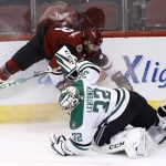 Dallas Stars goaltender Kari Lehtonen (32) collides with Arizona Coyotes left wing Jordan Martinook during the third period of an NHL hockey game Thursday, Feb. 1, 2018, in Glendale, Ariz. The Stars defeated the Coyotes 4-1. (AP Photo/Ross D. Franklin)