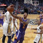 Phoenix Suns guard Elfrid Payton (2) is blocked by New Orleans Pelicans forward Anthony Davis as he drives to the basket in the first half of an NBA basketball game in New Orleans, Monday, Feb. 26, 2018. (AP Photo/Gerald Herbert)