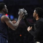 Indiana Pacers' Victor Oladipo, left, takes a mask from the movie "Black Panther" from actor Chadwick Boseman during the NBA basketball All-Star weekend slam dunk contest Saturday, Feb. 17, 2018, in Los Angeles. (AP Photo/Chris Pizzello)