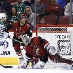 Dallas Stars center Devin Shore (17) flips the puck up and over Arizona Coyotes goaltender Scott Wedgewood, right, for a goal as Coyotes defenseman Niklas Hjalmarsson (4) watches during the second period of an NHL hockey game Thursday, Feb. 1, 2018, in Glendale, Ariz. (AP Photo/Ross D. Franklin)
