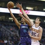Charlotte Hornets guard Jeremy Lamb (3) drives to the basket as Phoenix Suns' Dragan Bender defends during the second half of an NBA basketball game Sunday, Feb. 4, 2018, in Phoenix. (AP Photo/Ralph Freso)