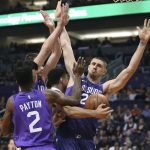 Denver Nuggets guard Jamal Murray, center, collides with Phoenix Suns' Alex Len, right, as he tries to drive to the basket between the Suns' Elfrid Payton (2) and Dragan Bender during the first half of an NBA basketball game, Saturday, Feb. 10, 2018, in Phoenix. (AP Photo/Ralph Freso)