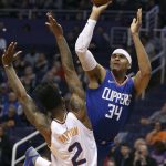 Los Angeles Clippers forward Tobias Harris (34) shoots over the defense of Phoenix Suns' Elfrid Payton during the first half of an NBA basketball game, Friday, Feb. 23, 2018, in Phoenix. (AP Photo/Ralph Freso)