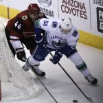 Vancouver Canucks center Bo Horvat (53) shields Arizona Coyotes defenseman Kevin Connauton from the puck in the second period during an NHL hockey game, Sunday, Feb. 25, 2018, in Glendale, Ariz. (AP Photo/Rick Scuteri)