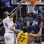 Phoenix Suns center Tyson Chandler (4) tips the ball in for a score over Utah Jazz center Rudy Gobert (27) during the first half of an NBA basketball game Friday, Feb. 2, 2018, in Phoenix. (AP Photo/Ross D. Franklin)