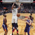 New Orleans Pelicans forward Anthony Davis (23) slam dunks between Phoenix Suns guard Devin Booker (1) and forward TJ Warren in the second half of an NBA basketball game in New Orleans, Monday, Feb. 26, 2018. The Pelicans won 125-116. (AP Photo/Gerald Herbert)