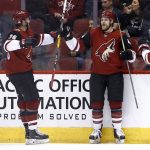 Arizona Coyotes defenseman Kevin Connauton, middle, celebrates his goal against the Dallas Stars with right wing Christian Fischer (36) and center Nick Cousins, right, during the first period of an NHL hockey game, Thursday, Feb. 1, 2018, in Glendale, Ariz. (AP Photo/Ross D. Franklin)