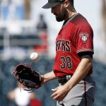 Arizona Diamondbacks pitcher Robbie Ray flips the baseball into his glove between pitches against the Cincinnati Reds during the first inning of a spring training baseball game Monday, Feb. 26, 2018, in Goodyear, Ariz. (AP Photo/Ross D. Franklin)