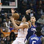 Phoenix Suns guard Devin Booker (1) has his shot blocked by Los Angeles Clippers' Sam Dekker (7) during the first half of an NBA basketball game, Friday, Feb. 23, 2018, in Phoenix. (AP Photo/Ralph Freso)