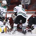 Arizona Coyotes goaltender Scott Wedgewood, second from left, makes a save as Dallas Stars right wing Alexander Radulov (47) and center Tyler Seguin, second from right, and Coyotes defenseman Niklas Hjalmarsson (4) wait for a possible rebound during the second period of an NHL hockey game Thursday, Feb. 1, 2018, in Glendale, Ariz. (AP Photo/Ross D. Franklin)