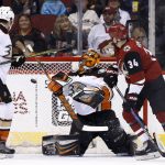 Anaheim Ducks goaltender Ryan Miller, middle, gives up a goal to Arizona Coyotes' Jason Demers as Ducks defenseman Cam Fowler (4) and Coyotes center Zac Rinaldo (34) look for the puck during the first period of an NHL hockey game Saturday, Feb. 24, 2018, in Glendale, Ariz. (AP Photo/Ross D. Franklin)