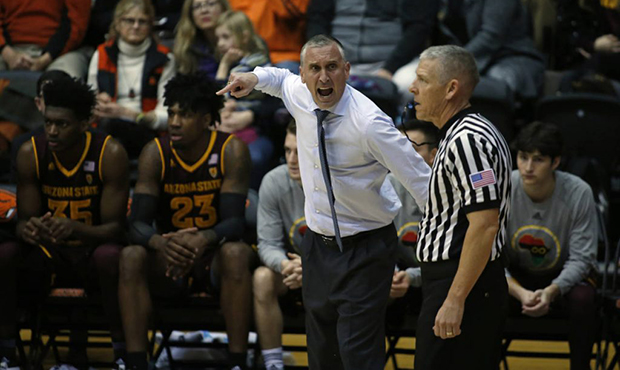 Arizona State head coach Bobby Hurley, center, disagrees with a call in the first half of an NCAA c...