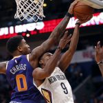 Phoenix Suns forward Marquese Chriss (0) blocks a shot by New Orleans Pelicans guard Rajon Rondo (9) in the first half of an NBA basketball game in New Orleans, Monday, Feb. 26, 2018. (AP Photo/Gerald Herbert)