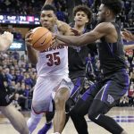 Arizona's Allonzo Trier is fouled by Washington's Jaylen Nowell, right, as Matisse Thybulle trails during the second half of an NCAA college basketball game Saturday, Feb. 3, 2018, in Seattle. Washington won 78-75. (AP Photo/John Froschauer)