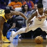 Phoenix Suns forward Marquese Chriss (0) and Utah Jazz guard Donovan Mitchell (45) dive after a loose ball during the first half of an NBA basketball game Friday, Feb. 2, 2018, in Phoenix. (AP Photo/Ross D. Franklin)