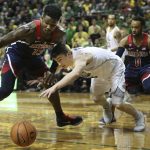 Arizona's DeAndre Ayton, left, and Oregon's Payton Pritchard, with Arizona's Parker Jackson-Cartwright, right, battle for the ball during the first half of an NCAA college basketball game Saturday, Feb. 24, 2018, in Eugene, Ore. (AP photo/Chris Pietsch)