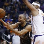 San Antonio Spurs guard Tony Parker, middle, is fouled as he drives past Phoenix Suns forward Jared Dudley (3) as Suns forward TJ Warren, left, watches during the first half of an NBA basketball game Wednesday, Feb. 7, 2018, in Phoenix. (AP Photo/Ross D. Franklin)
