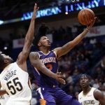 Phoenix Suns guard Elfrid Payton, center, goes to the basket in front of New Orleans Pelicans guard E'Twaun Moore (55) in the second half of an NBA basketball game in New Orleans, Monday, Feb. 26, 2018. (AP Photo/Gerald Herbert)