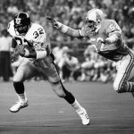 FILE - In this Dec. 3, 1978, file photo, Pittsburgh Steelers running back Franco Harris (32) picks up 10 yards as he turns the corner as Houston Oilers' Robert Brazile (52) makes a dive to latch on to Harris to make the stop, during an NFL football game in Houston. Brazile was elected to the Pro Football Hall of Fame on Saturday, Feb. 3, 2018. (AP Photo/Ed Kolenovsky, File)