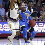 UCLA guard Aaron Holiday (3) drives on Arizona State guard Tra Holder in the first half during an NCAA college basketball game, Saturday, Feb. 10, 2018, in Tempe, Ariz. (AP Photo/Rick Scuteri)