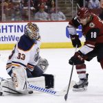 Edmonton Oilers goaltender Cam Talbot (33) makes a save on a shot by Arizona Coyotes center Christian Dvorak (18) during the second period of an NHL hockey game Saturday, Feb. 17, 2018, in Glendale, Ariz. (AP Photo/Ross D. Franklin)