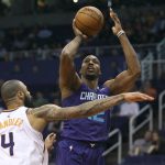 Charlotte Hornets center Dwight Howard, right, shoots over the defense of Phoenix Suns' Tyson Chandler during the first half of an NBA basketball game Saturday, Feb. 4, 2018, in Phoenix. (AP Photo/Ralph Freso)