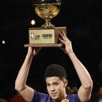 Phoenix Suns' Devin Booker holds up his trophy after winning the NBA All-Star basketball 3-Point contest, Saturday, Feb. 17, 2018, in Los Angeles. (AP Photo/Chris Pizzello)