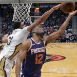 New Orleans Pelicans forward Anthony Davis, left, blocks a shot by Phoenix Suns forward TJ Warren (12) in the first half of an NBA basketball game in New Orleans, Monday, Feb. 26, 2018. (AP Photo/Gerald Herbert)