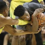 Oregon's Elijah Brown, left, reaches for the ball held by Arizona State's Shannon Evans II during the first half of an NCAA college basketball game Thursday, Feb. 22, 2018, in Eugene, Ore. (AP Photo/Chris Pietsch)