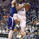 Phoenix Suns forward Josh Jackson, right, drives to the basket past Los Angeles Clippers' Tobias Harris during the second half of an NBA basketball game Friday, Feb. 23, 2018, in Phoenix. The Clippers defeated the Suns 128-117. (AP Photo/Ralph Freso)