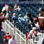 Arizona Diamondbacks' Jeremy Hazelbaker (41) celebrates his two-run home run against the Cincinnati Reds with teammate Kevin Cron (68) during the second inning of a spring training baseball game Monday, Feb. 26, 2018, in Goodyear, Ariz. (AP Photo/Ross D. Franklin)