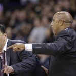 Arizona coach Sean Miller, left, and associate head coach Lorenzo Romar, right, call out from the bench during the second half of the team's NCAA college basketball game against Washington on Saturday, Feb. 3, 2018, in Seattle. Washington won 78-75. (AP Photo/John Froschauer)