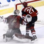 Arizona Coyotes goaltender Scott Wedgewood, left, collides with Arizona Coyotes defenseman Oliver Ekman-Larsson (23) as Wedgewood makes a save against the Dallas Stars during the third period of an NHL hockey game Thursday, Feb. 1, 2018, in Glendale, Ariz. The Stars defeated the Coyotes 4-1. (AP Photo/Ross D. Franklin)