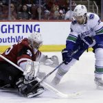 Arizona Coyotes goaltender Darcy Kuemper (35) makes the save on Vancouver Canucks center Brandon Sutter in the first period during an NHL hockey game, Sunday, Feb. 25, 2018, in Glendale, Ariz. (AP Photo/Rick Scuteri)