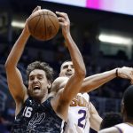 San Antonio Spurs center Pau Gasol (16) grabs a rebound in front of Phoenix Suns center Alex Len (21) during the second half of an NBA basketball game Wednesday, Feb. 7, 2018, in Phoenix. The Spurs defeated the Suns 129-81. (AP Photo/Ross D. Franklin)