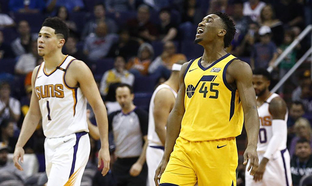 Utah Jazz guard Donovan Mitchell (45) shouts in celebration after making a 3-pointer as Phoenix Sun...
