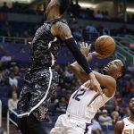 Phoenix Suns forward TJ Warren (12) gets off a shot over San Antonio Spurs guard Danny Green, left, during the second half of an NBA basketball game Wednesday, Feb. 7, 2018, in Phoenix. The Spurs defeated the Suns 129-81. (AP Photo/Ross D. Franklin)
