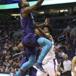 Charlotte Hornets guard Michael Kidd-Gilchrist, left, drives to the basket past Phoenix Suns' Josh Jackson during the first half of an NBA basketball game Saturday, Feb. 4, 2018, in Phoenix. (AP Photo/Ralph Freso)