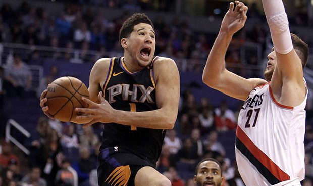 Phoenix Suns guard Devin Booker (1) drives on Portland Trail Blazers center Jusuf Nurkic during the...