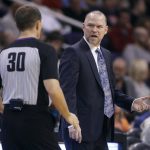 Denver Nuggets coach Michael Malone, right, questions official John Goble about a call during the second half of the team's NBA basketball game against the Phoenix Suns, Saturday, Feb. 10, 2018, in Phoenix. The Nuggets defeated the Suns 123-113. (AP Photo/Ralph Freso)
