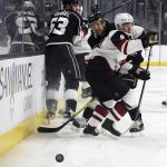 The puck rolls away as Arizona Coyotes center Clayton Keller (9), Los Angeles Kings defenseman Kevin Gravel (53) and others scrum during the first period of an NHL hockey game in Los Angeles Saturday, Feb. 3, 2018. (AP Photo/Reed Saxon)
