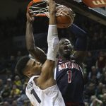 Oregon's Kenny Wooten, left, fouls Arizona's Rawle Alkins on a dunk during the second half of an NCAA college basketball game Saturday, Feb. 24, 2018, in Eugene, Ore. (AP Photo/Chris Pietsch)