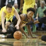 Oregon's Payton Pritchard, left, and Arizona State's Kimani Lawrence and Remy Martin, right, go the floor after a loose ball during the second half of an NCAA college basketball game Thursday, Feb. 22, 2018, in Eugene, Ore. (AP Photo/Chris Pietsch)