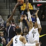 Arizona's Allonzo Trier, left, shoots over Oregon's Elijah Brown, MiKyle McIntosh, center, and Kenny Wooten during the first half of an NCAA college basketball game Saturday, Feb. 24, 2018, in Eugene, Ore. (AP photo/Chris Pietsch)