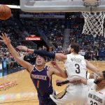 Phoenix Suns guard Devin Booker (1) goes to the basket against New Orleans Pelicans forward Nikola Mirotic (3) in the first half of an NBA basketball game in New Orleans, Monday, Feb. 26, 2018. (AP Photo/Gerald Herbert)
