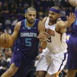 Charlotte Hornets forward Nicolas Batum (5) drives to the basket past the defense of Phoenix Suns' Jared Dudley (3) during the first half of an NBA basketball game Saturday, Feb. 4, 2018, in Phoenix. (AP Photo/Ralph Freso)